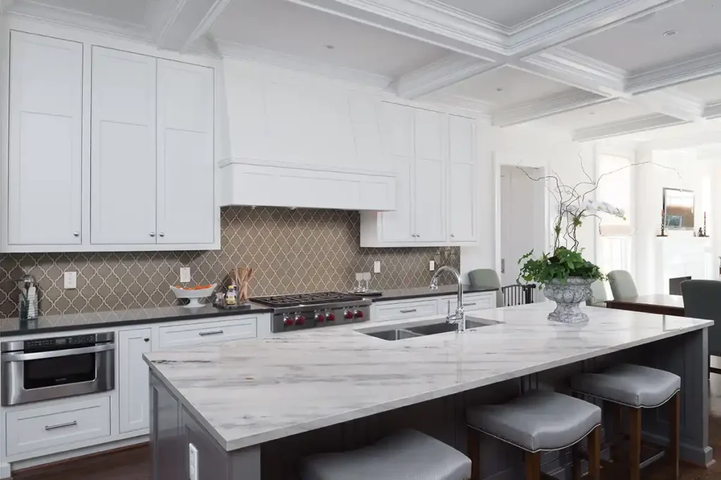 Modern kitchen with large white marble countertops and island