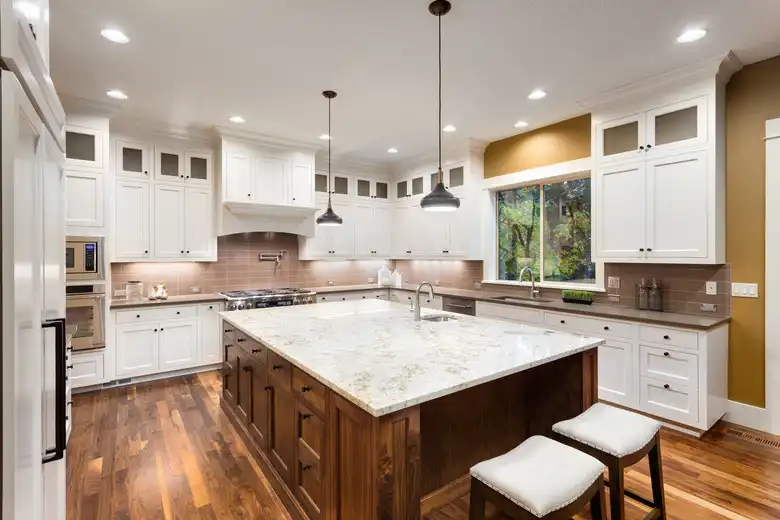 Kitchen Countertop Cost in 2026 showcased with large quartz island, white cabinets, and modern kitchen layout.