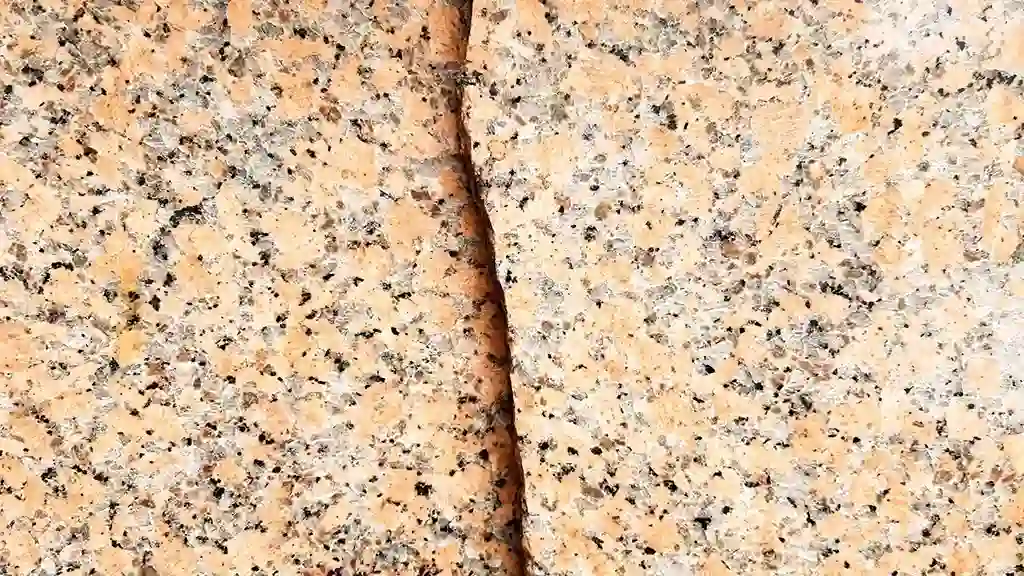 Close-up of a granite countertop crack showing the details of the cost of granite crack repair