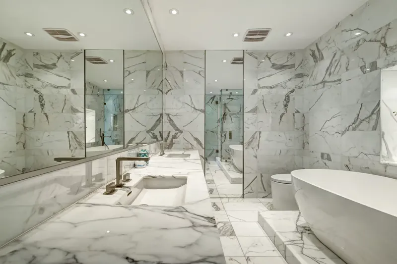 White marble tiles installed on a modern bathroom wall